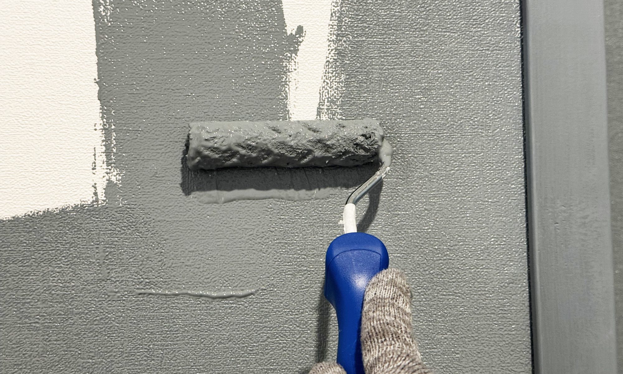 painter applying two caors of paint to a wall in Durbanville