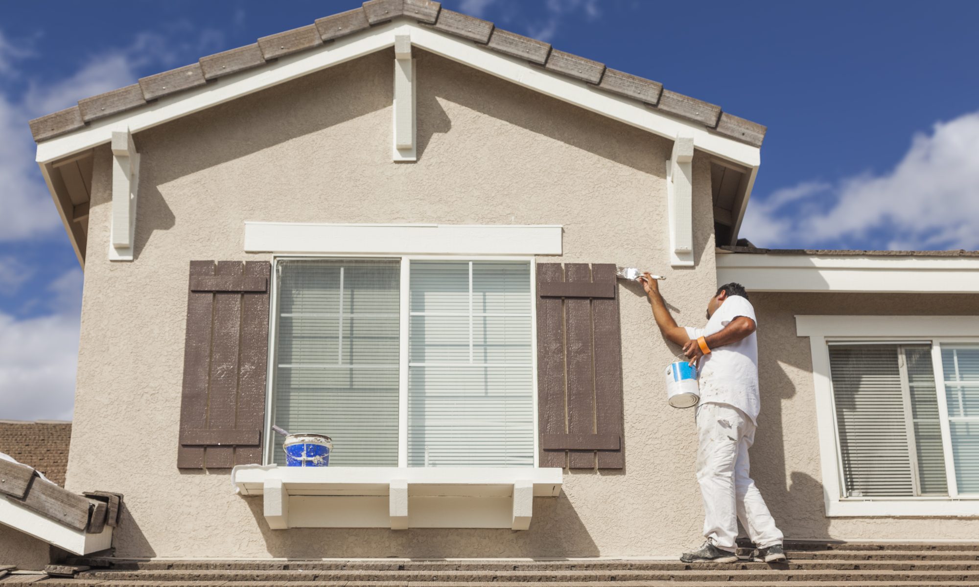 Busy House Painter Painting the Trim And Shutters of A Home in Stellenbosch.